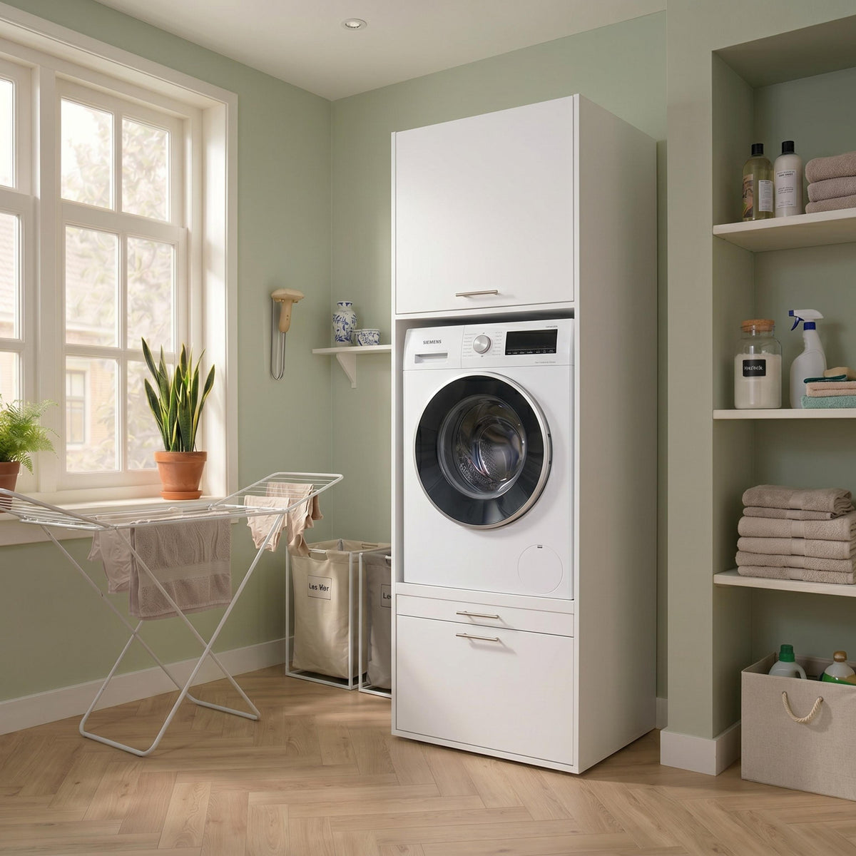 White front-loading washer and dryer stacked in a sage green laundry room beside a drying rack.