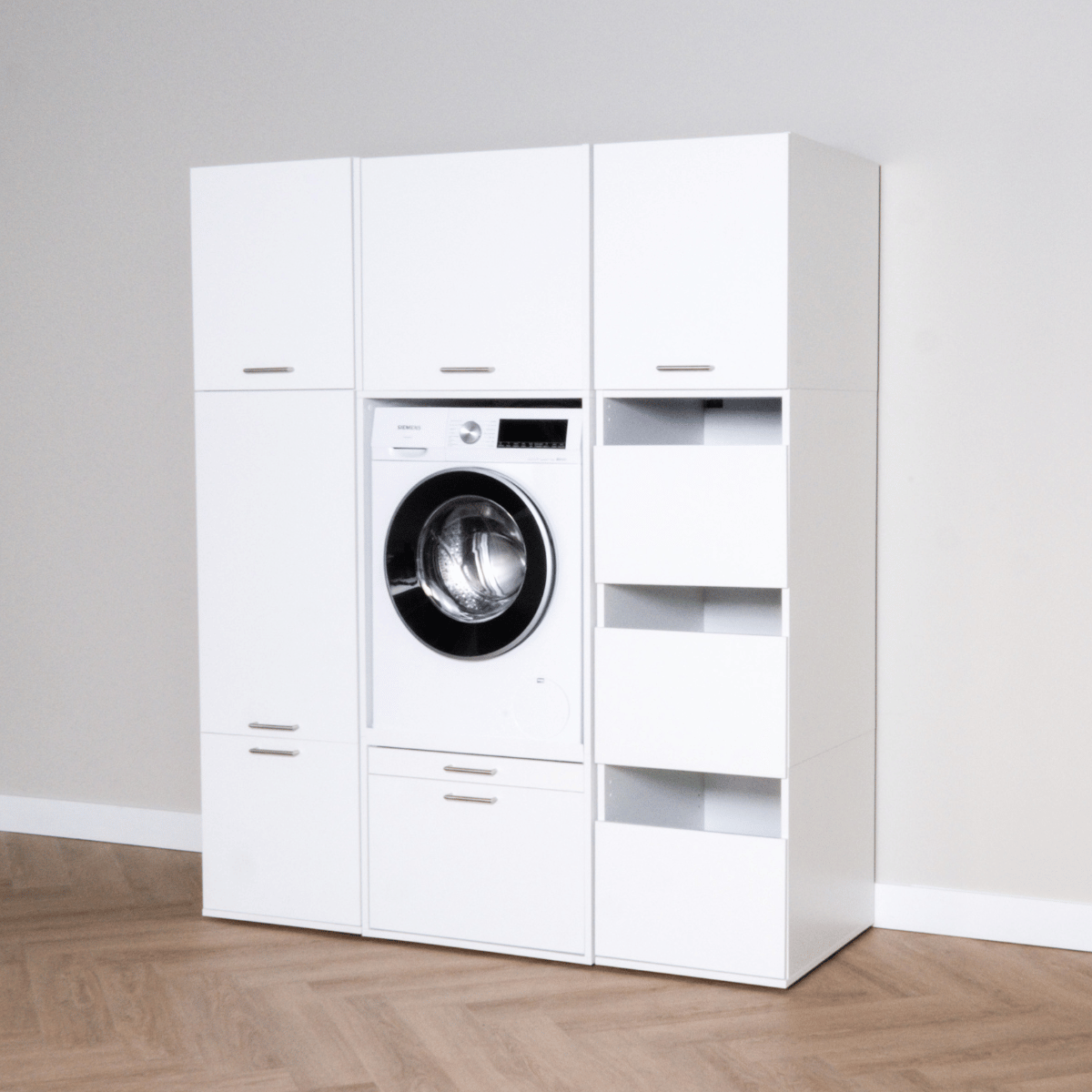 White laundry storage cabinet set with built-in front-load washing machine and open shelves.